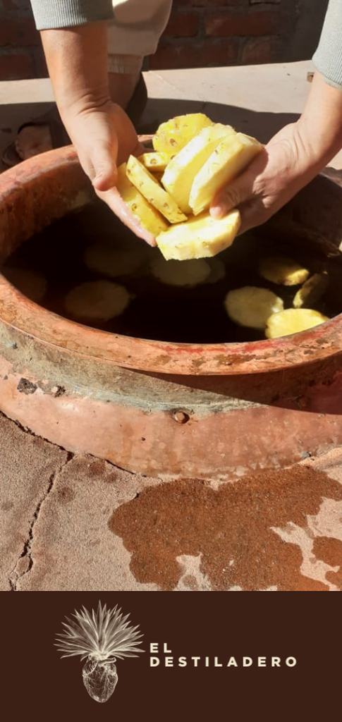 El maestro mezcalero haciendo su magia para lograr su mezcal destilado con piña